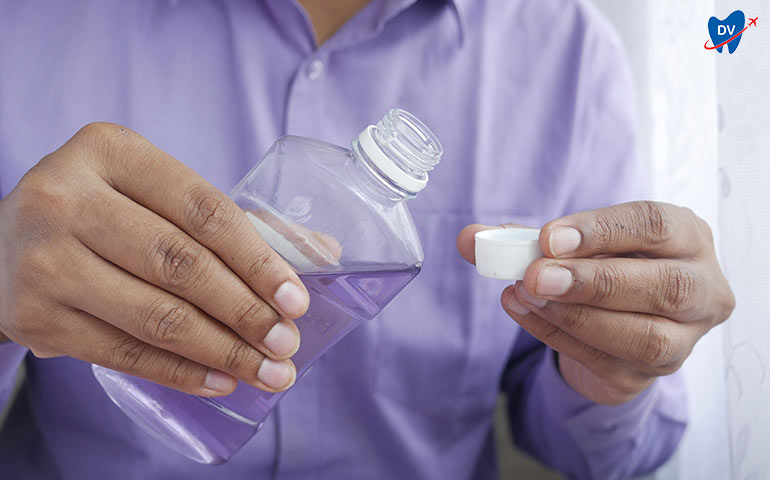 A Person Using Mouthwash