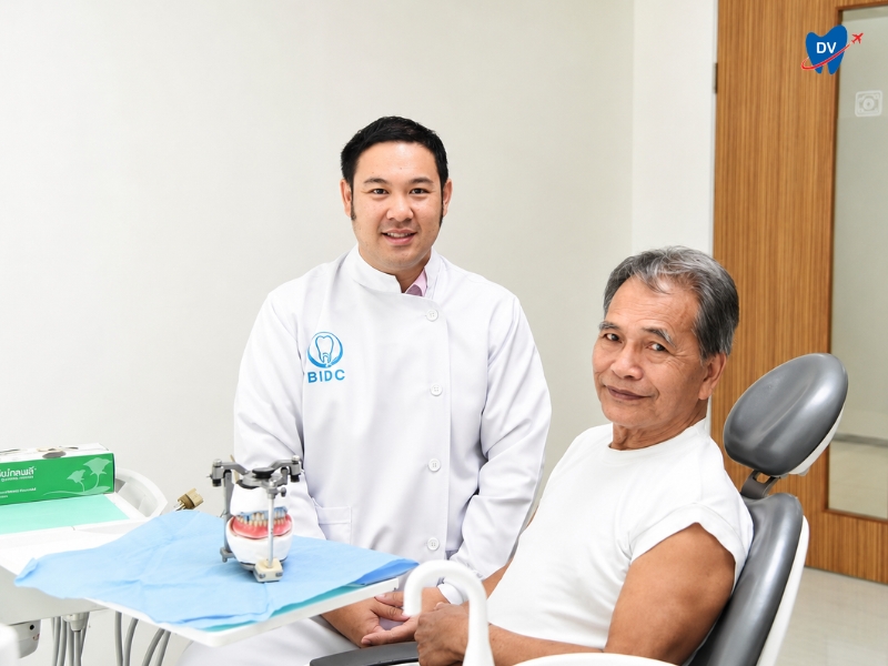 this is an image of Phuket Dental Signature clinic in Phuket, Thailand, in which a dentist is treating his male patient