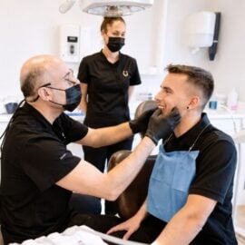 Dentist examining a patient's mouth inside the clinic